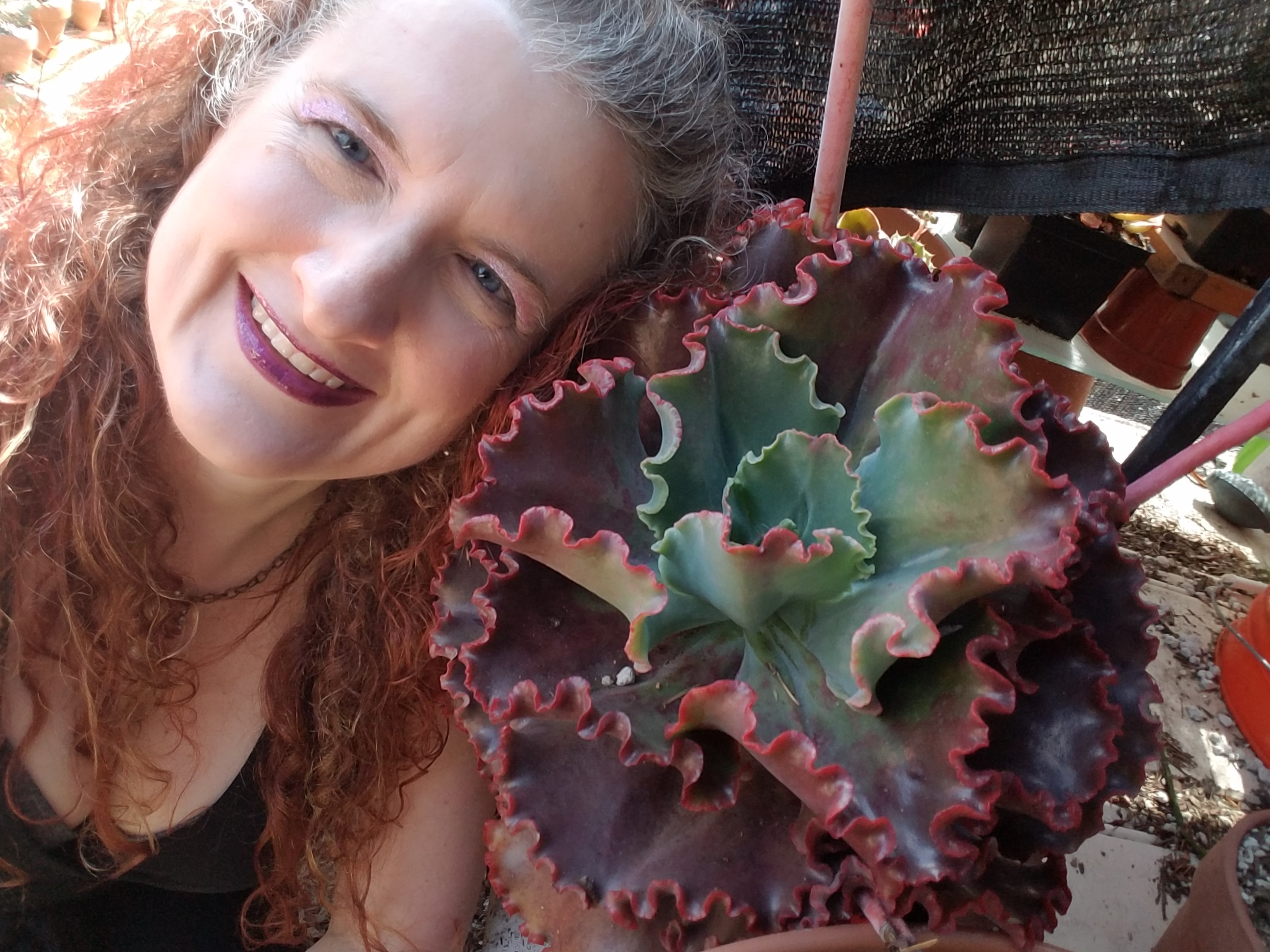 Cassie with red hair and a gorgeous succulent, 2021